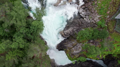 Top-down-shot,-pushing-in-on-a-raging-waterfall-in-Norway