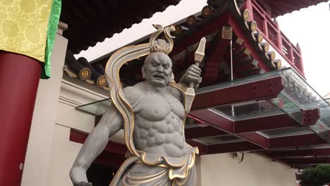 hindu-god-statue-in-front-of-colorful-window-shutters-and-architecture-on-Tan-Teng-Niah-old-traditional-Chinese-trading-house-in-the-Little-India-neighborhood-of-downtown-Singapore-in-Asia