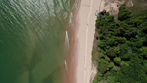 Drone-aerial-view-of-waves-crashing-in-on-the-beach-in-door-county,-Wisconsin