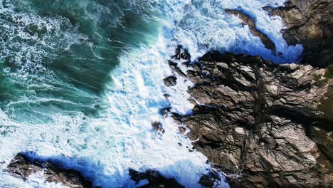 Atlantikwellen-In-Zeitlupe-Brechen-über-Die-Felsen-Von-Cornwall,-Während-Das-Wasser-Wild-Plätschert
