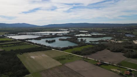 Panoramic-aerial-dolly-above-farmland-plot-fields-and-ancient-Antela-lagoon-Areeiras-da-Limia-in-Xinzo-de-Limia-Ourense-Galicia-Spain