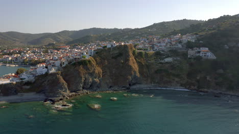 Aerial:-Reveal-shot-of-Skopelos-town-In-Skopelos-Island,-Sporades,-Greece-during-sunset