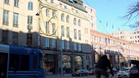 Tram-and-street-traffic-pass-by-department-store-NK-in-Stockholm