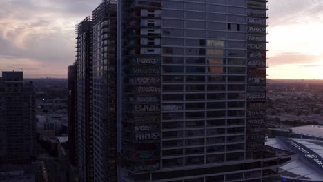 Aerial-low-panning-shot-of-the-Oceanwide-Plaza-graffiti-skyscrapers-at-sunset-in-downtown-Los-Angeles,-California