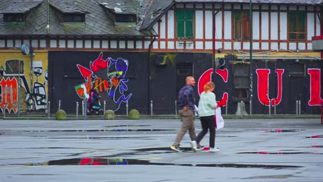 Graffiti-covered-buildings-in-Milan,-local-residents-go-about-their-day