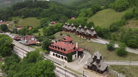 Mokra-Gora,-Serbia,-Aerial-View-of-Jatare-Train-Station,-Sargan-Eight-Railway,-Church-and-Wooden-Ethic-Houses,-Tourist-Attraction