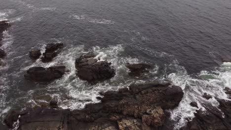 Aerial-top-down-Atlantic-Ocean-waves-crashing-in-to-rocky-coastline