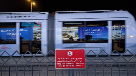 Dubai-Metro-Train-at-Night-Moving-on-Railroad