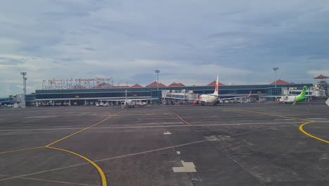 Ngurah-Rai-International-Airport,-Denpasar,-Bali,-Indonesia,-View-From-Airplane-on-Runway