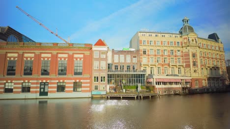 Tivoli-Doelen-hotel-and-cafe-de-Jaren-at-Amsterdam-Amstel-river-sunny-day