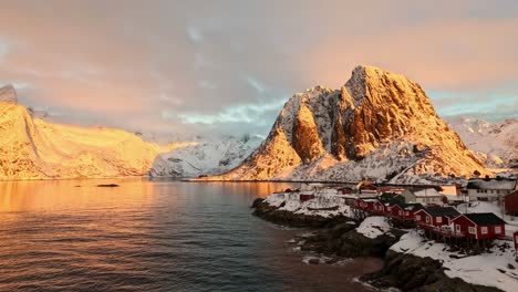 Slow-pan-from-Reinefjord-to-Festhaltinden-mountain-and-Hamnoy,-Winter-sunset-Lofoten-Norway