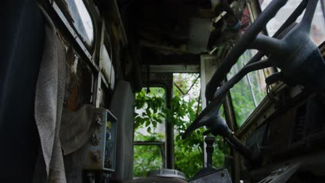 Pull-out-shot-of-an-abandoned-trucks-rotting-interior