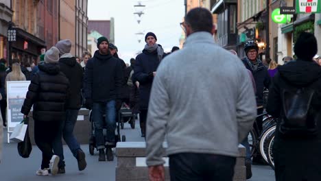 People,-bikes-and-stroller-on-pedestrian-street-in-Stockholm,-slomo
