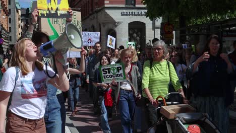 Girls-shout-with-megaphone-at-environmental-protest-march,-slo-mo