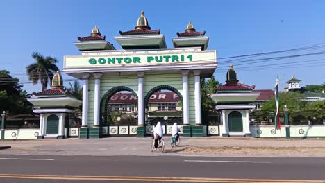 The-atmosphere-in-front-of-the-gate-of-the-Gontor-Putri-1-modern-Islamic-boarding-school,-Ngawi,-East-Java,-Indonesia