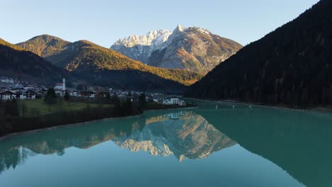 Beauiful-view-of-a-small-town-in-Dolomite,-surrounded-by-mountains,-water-and-forest