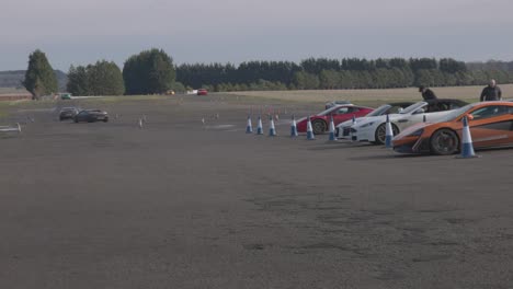 Static-shot-of-multiple-supercars-racing-around-a-track-in-Scotland