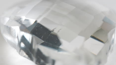 Macro-Shot-Of-Diamond-Like-Quartz-Rock-Rotating-Around-With-Flashing-Red-And-Blue-Light-In-Background