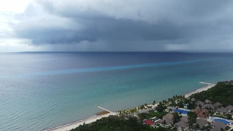 Coast-of-Cozumel-island-in-Caribbean-sea-with-stormy-sky-in-background,-Mexico