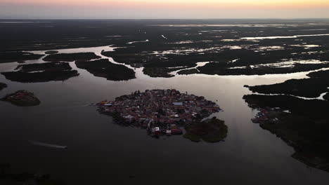 Drone-shot-tilting-toward-the-Mexcaltitan-town,-vibrant-dusk-in-Nayarit,-Mexico