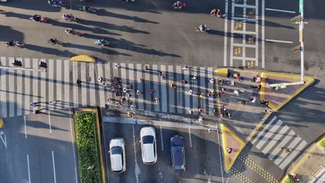People-walking-on-pedestrians-crossing,-Santo-Domingo-city-in-Dominican-Republic