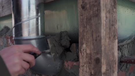 The-Man-is-Filling-the-Spaces-Between-the-Bricks-Beneath-the-DIY-Hot-Tub---Close-Up