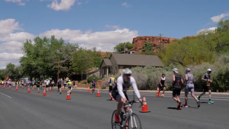Slow-motion-shot-of-people-running-and-one-person-on-racer-bike-at-the-Intermountain-Health-IRONMAN-70