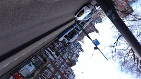 Creative-rotating-shot-of-oncoming-traffic-and-tram-system-in-downtown-Amsterdam,-Netherlands