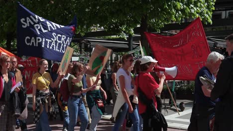 Junge-Demonstranten-Marschieren-Mit-Transparenten-Und-Megafon-Bei-Klimakundgebung