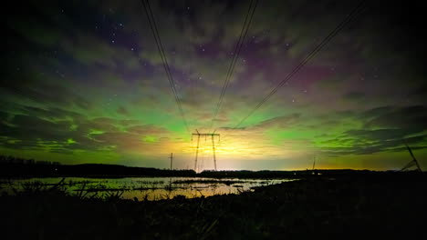 Time-lapse-of-a-magnetic-storm-sky-above-electric-lines-and-a-pylon-on-the-countryside