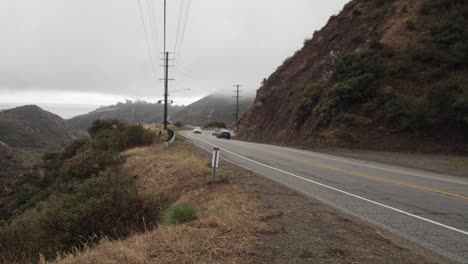 Malibu-Canyon-Road-in-Malibu,-California-with-vehicles-driving-and-stable-video