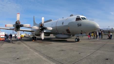 Propellor-airplane-on-the-runway-with-people-touring-the-vehicle