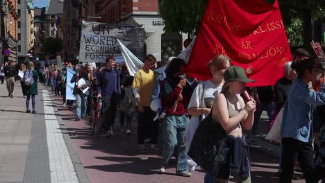 Young-people-march-with-signs-and-banners-at-climate-rally,-slo-mo