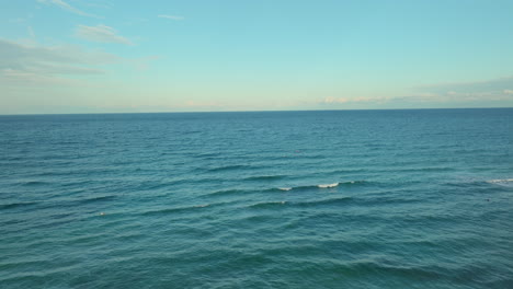Calm-blue-sea-with-gentle-waves-under-clear-skies