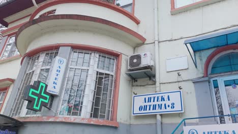 Flashing-LED-cross-symbol-information-sign-for-Bulgarian-chemist-drugstore