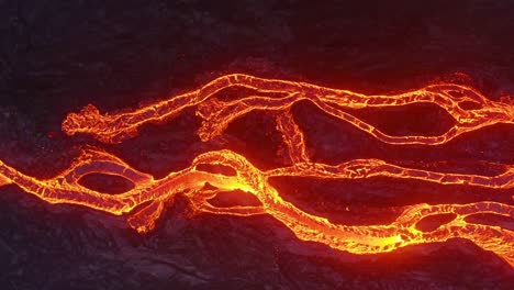 Close-up-aerial-shots-captured-by-a-unique-4K-drone-showcase-cinematic-views-of-cascading-lava,-forming-shapes-reminiscent-of-tree-roots