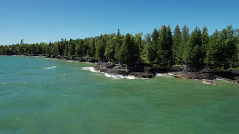 Large-waves-crash-against-the-rocks-of-door-county-on-a-windy-and-sunny-day