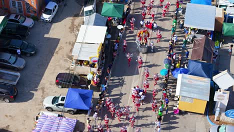 Red-white-feathered-costumes-sparkle-as-performers-dance-in-the-street-for-Carnval-Grand-March-in-Curacao