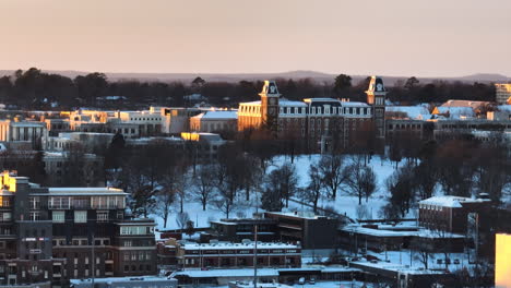Golden-hour-over-Washington-County-Courthouse-with-snowy-Fayetteville-backdrop,-tranquil-dusk-setting