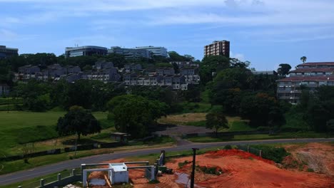 Morning-side-Durban-South-Africa-on-a-hot-semi-cloudy-day-in-summer-drone-flying-down-toward-construction-site