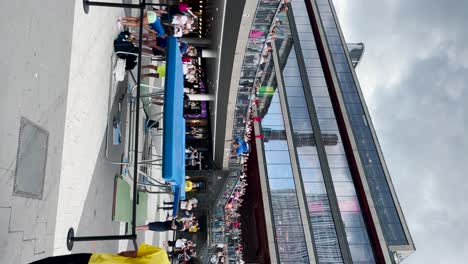 Woman-does-tricks-jumping-on-trampoline-at-show-in-Sweden,-vertical