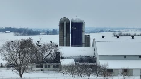 Farm-with-silos-and-barn-in-Lancaster-County-during-winter-snow