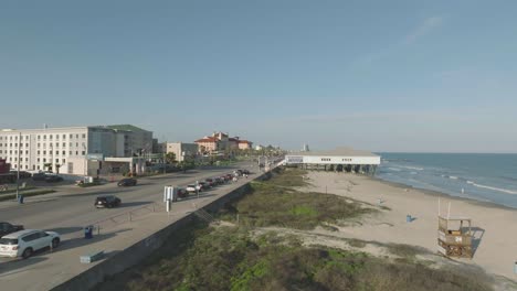 A-late-afternoon-aerial-view,-zooming-out-from-Murdoch's-and-The-Grand-Galvez-on-the-Seawall-in-Galveston,-Texas