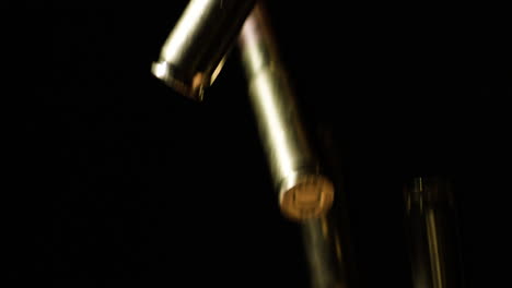 Slow-Motion-Of-300-BLK-Cartridges-Falling-Black-Background