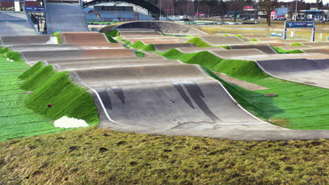 Maris-Strombergs-BMX-track-on-sunny-spring-day,-aerial-view