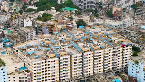 People-Walking-On-Rooftop-Of-Apartment-Building-In-Dhaka-City,-Bangladesh