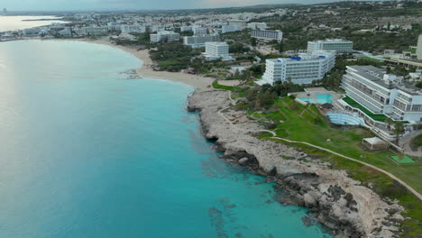 Ayia-Napa-resorts-and-rocky-coastline-in-aerial-dolly-out-view,-Cyprus,-Europe