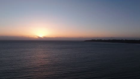 Drone-aerial-shot-of-the-sunset-over-the-pacific-ocean-in-California