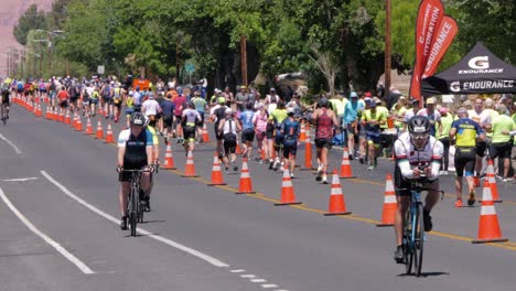 Slow-motion-shot-of-cyclists-in-front-and-runners-in-the-background-at-the-Intermountain-Health-IRONMAN-70