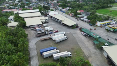 Delivery-Trucks-Parked-At-Parking-Garage-Along-The-Road-In-Virac,-Catanduanes,-Philippines